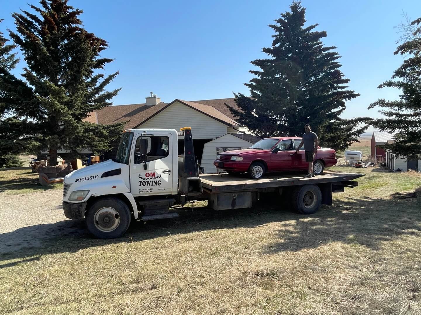 estate clearing - flat bed truck with car