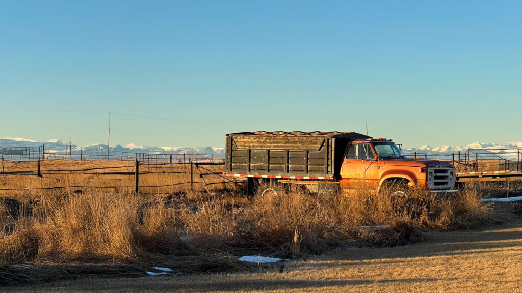 red truck against rocky mountains